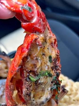 Grilled lobster tail with garlic butter over mac n cheese